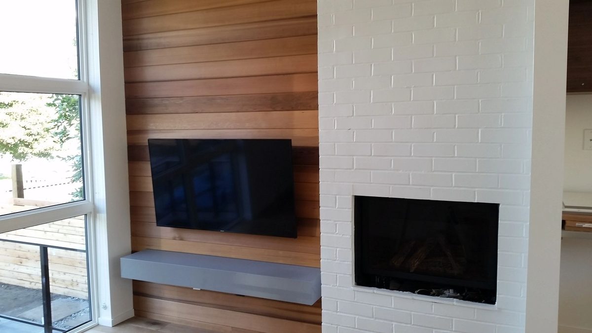 TV mounted on a timber plank feature wall