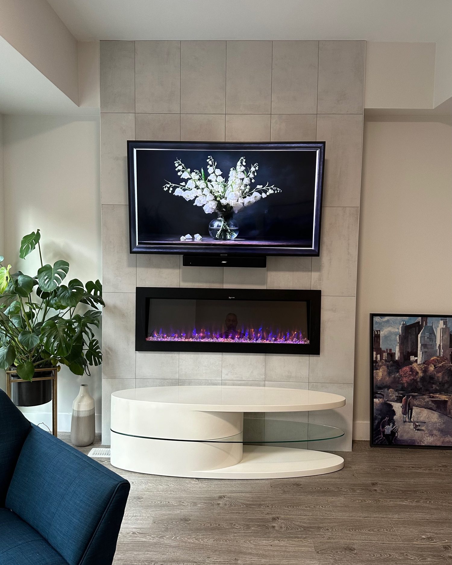 TV and soundbar mounted on the porcelain tile wall with the outlet hidden behind the panel